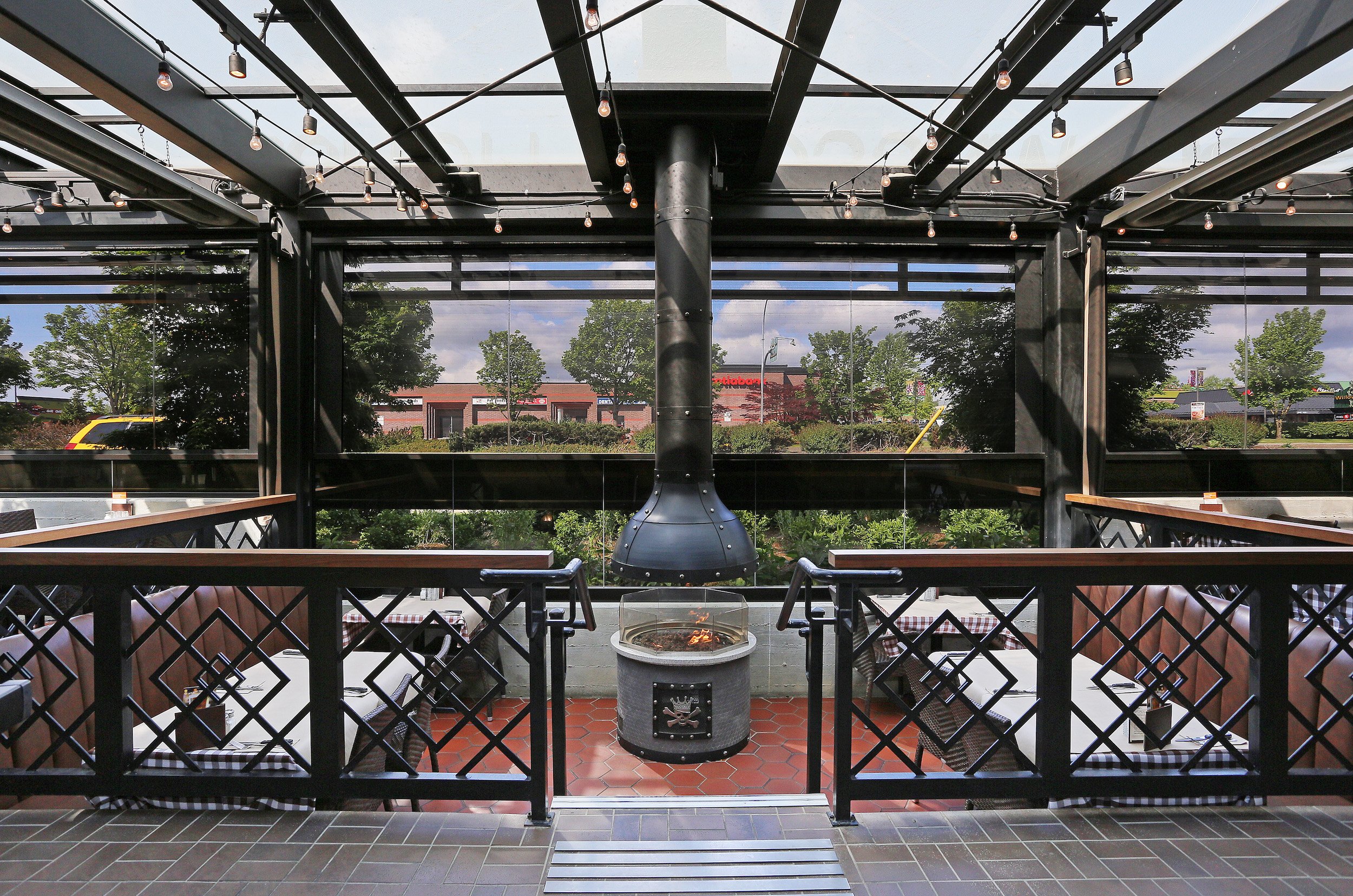 Restaurant patio with fire pit and motorized Phantom screens