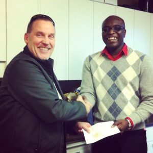 Les Talvio from the Cyrus Centre accepts a cheque from our Brand Marketing Manager, Paul Ackah-Sanzah