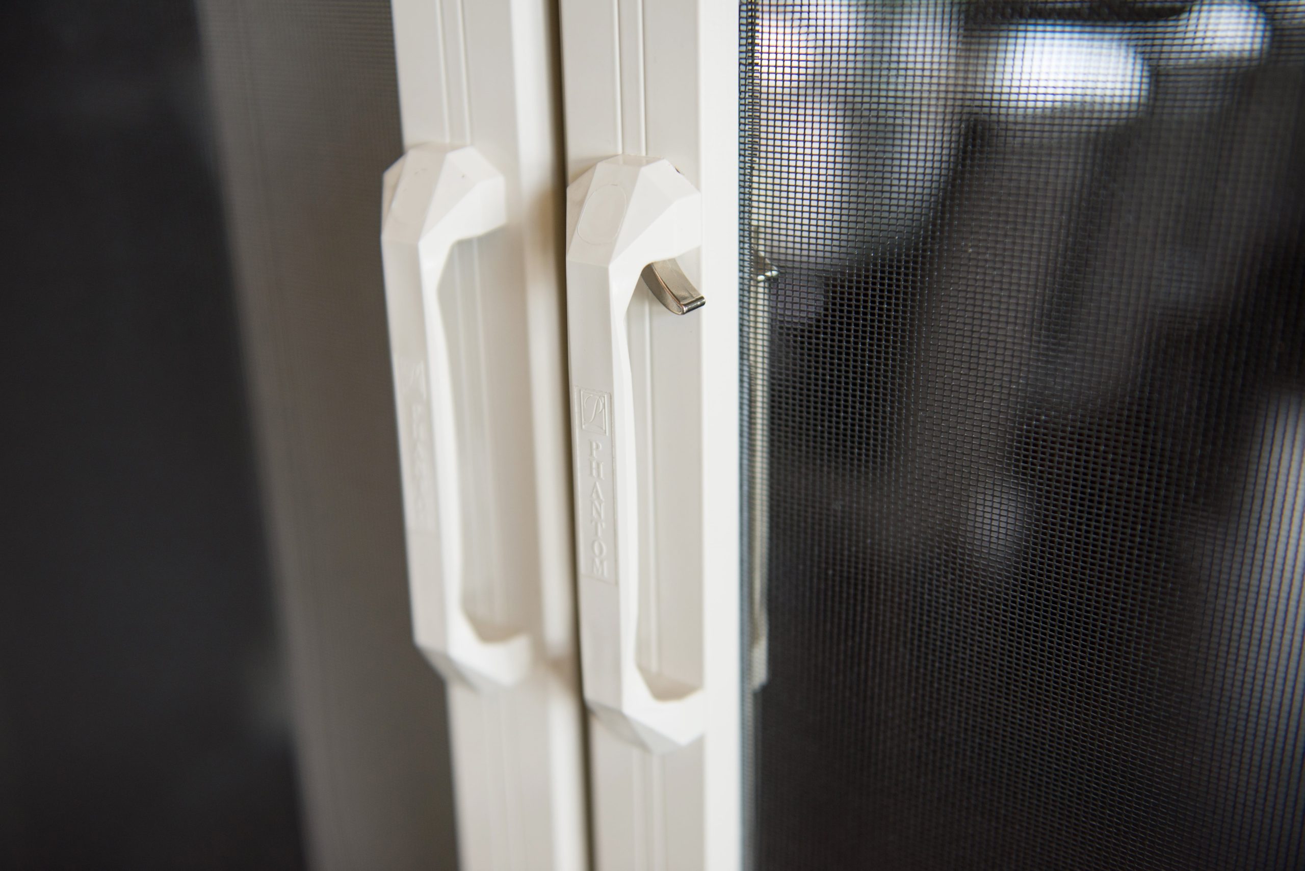 Close up of latching handles for retractable door screens