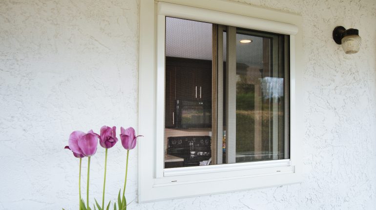 Close of home with retractable sliding window screens