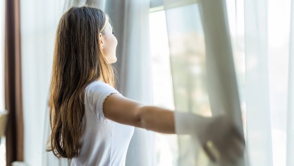 Woman looks out Windows