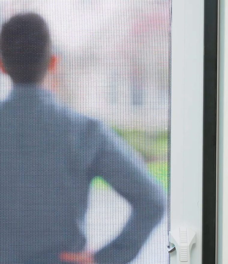 man standing outside locked retractable door screen