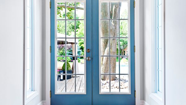 Blue French doors in country home leading to outdoor space