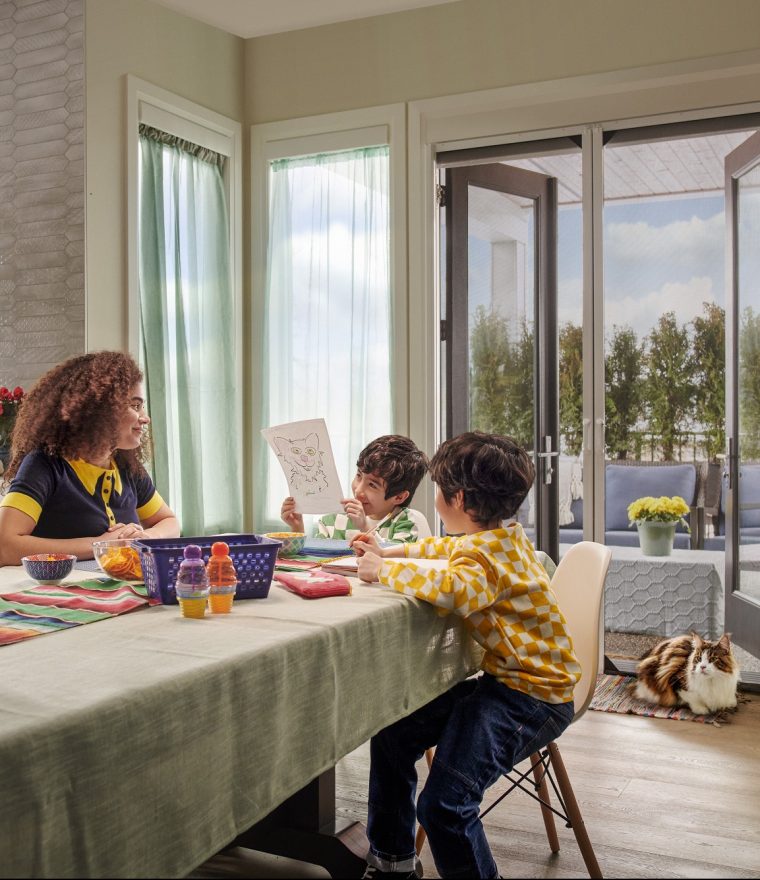 Family sitting at table with double doors with retractable door screens