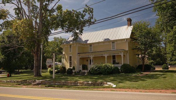 A old yellow Southern Victorian home now named The Spa